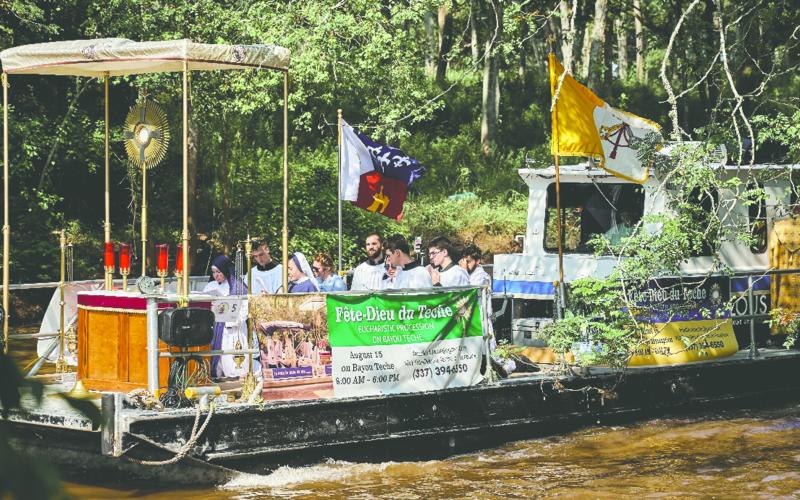 A boat carrying the Blessed Sacrament processes down the Bayou Teche during a previous Fête-Dieu du Teche. (Submitted photo)
