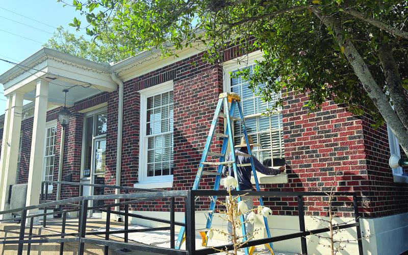 A crewmember is pictured as he works on the front exterior of the building that houses the Evangeline Chamber of Commerce and Evangeline Parish Tourist Commission. The work is through a grant program that was announced during the Ville Platte City Council meeting held Tuesday, May 12. (Gazette photo by Tony Marks)