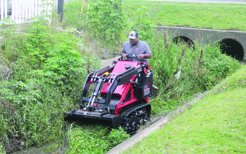 Ville Platte Mayor Ryan Leday Williams is pictured as he clears a portion of a canal located at the intersection of Tate Cove Road and E. Jefferson Street. (Gazette photo by Tony Marks)
