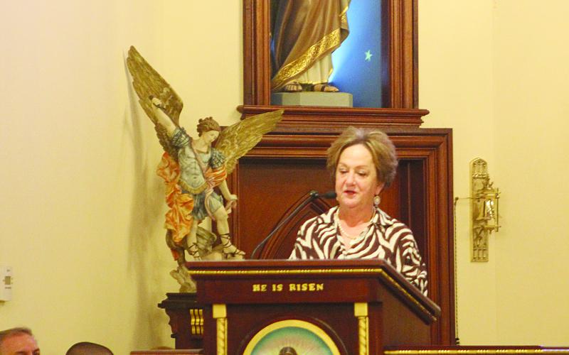 Therese Olivier, a sister of Charlene Richard, leads the Rosary prior to the Mass at St. Edward Catholic Church in Richard. (Gazette photo by Tony Marks)