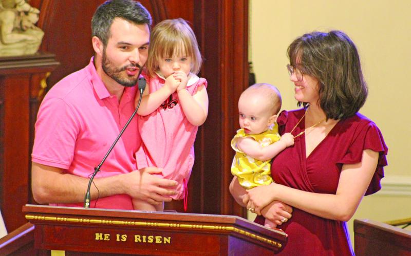 The Stansbury Family, Ryan and Sophie and their daughters Cecilia and Charlene, address the crowd at the annual Charlene Richard Mass. The family prayed to the “The Little Cajun Saint” for a healthy birth of their daughter Charlene. (LSN photo by Claudette Olivier)
