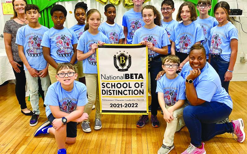 CHATAIGNIER BETA CLUB RECEIVES HONOR - Members of the Chataignier Beta Club gather around the banner. Kneeling in front are Parker Bertrand, and Korbin Fontenot and sponsor Sherelene Johnson. In the center holding the banner are Brooklyn Soileau, left; and Layla Boudreaux, right. Standing in back, from left, are assistant principal Leslie DesHotels, Liam Celestine, Sterling Coleman Jr., Jillian Malbrew, Sage Papillion, Ty Ardoin, Peyton Thibodeaux, Sadie LeBleu, Mika Thibodeauux and Jordyn Manuel.