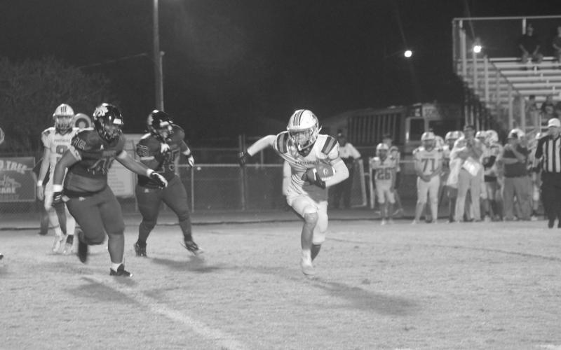 Cayden Fontenot (4) looks for daylight between him and a couple of Church Point defenders in Pine Prairie’s 54-14 loss in the district opener. (Gazette photo by Rhett Manuel)
