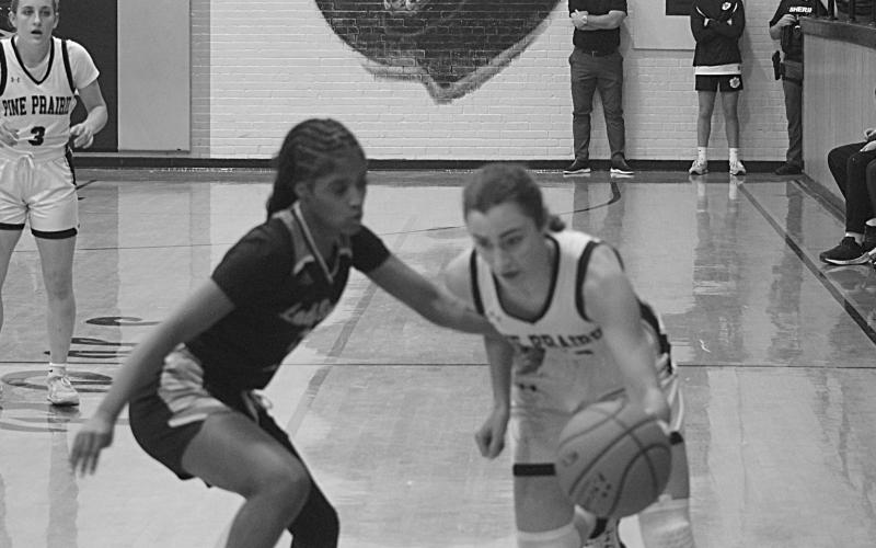 Pine Prairie’s Jolie Redmon (10) tries to maintain possession of the basketball against Church Point. She led the Lady Panthers with 7 points in a 47-10 loss. (Gazette photo by Tony Marks)