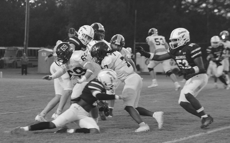 The Mamou defense converges to make a stop against a Church Point runner in the Green Demons’ 46-26 home loss to begin district play. (Gazette photo by Sylis Manuel)