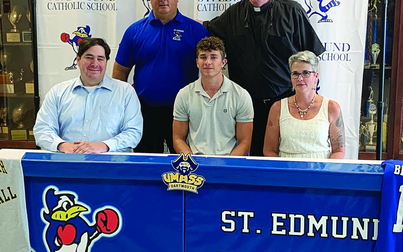 Bayou Chicot’s Easten Coleman signed to play football with University of Massachusetts Dartmouth. He is pictured seated in the center with his father Matt Coleman (left) and mother Jodi Crosby (right). Standing from  left are St. Ed’s Coach James Shiver and St. Anthony of Padua Pastor Fr. Hampton Davis. (Gazette photo by Rhett Manuel)