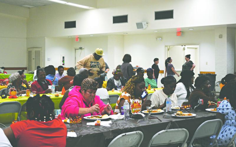 SPECIAL THANKSGIVING CELEBRATION HELD - The Second Annual Community Thanksgiving gathering and meal was held at the Northside Civic Center on Sunday, November 23. A large turn out enjoyed the delicious meal and fellowship. Pictured above, those in attendance dig into the homecooked meal prepared and sponsored by members of the community.