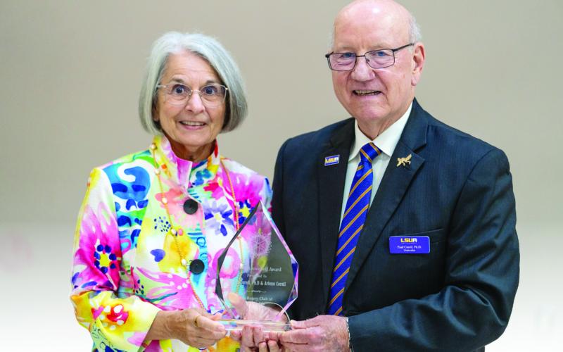 Arlene (left) and Paul Coreil (right) are pictured with their 2026 Service Above Self Award, which was presented by the Rotary Club of Alexandria. (Photo by Nathan Parish)
