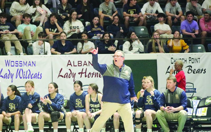 Sacred Heart head girls’ basketball coach Craig Whittington (left photo) and Oakdale head girls’ basketball coach Renotta Edwards (right photo) are pictured during their respective teams’ appearances in the semifinals of the LHSAA Girls’ Marsh Madness. (Gazette photos by Tony Marks)