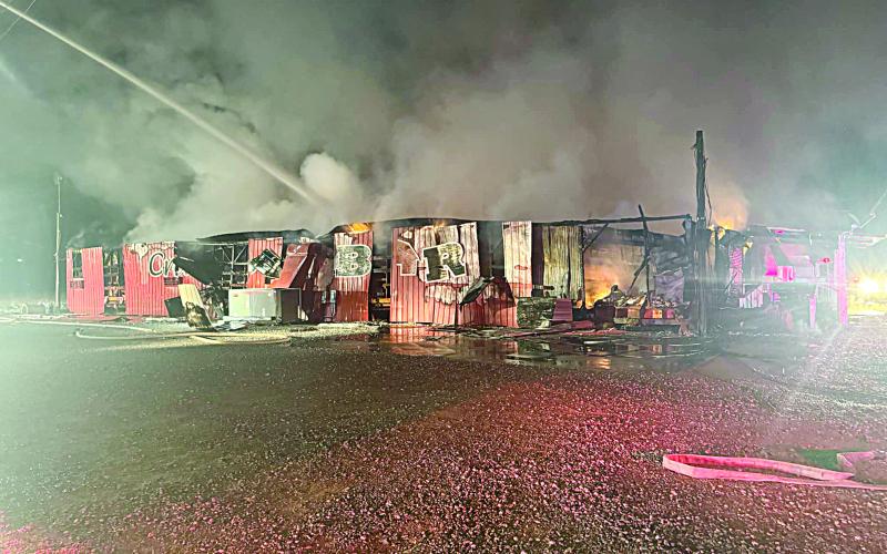 (Left photo) Firefighters work to put out the fire at The Crawfish Barn shortly after midnight on Saturday, January 25. (Photo courtesy of Jeffrey Veillon and by Ty Soileau)