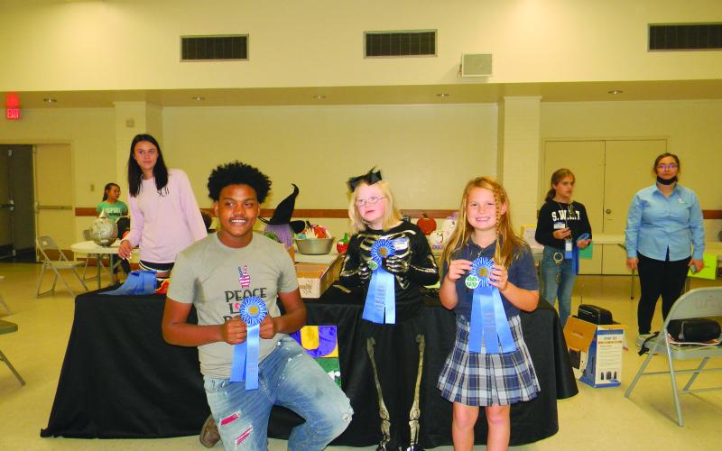 From left, are Jordan Edwards, Aubrey LaHaye and Emy Figueredo, winners in the Rice Cookery divisions.