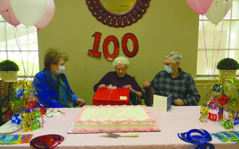 GIFTS FOR THE BIRTHDAY GIRL - Hattie Pouncey opens her gifts as her son Greg Fontenot, right and daughter-in-law Sharon Fontenot, right, look on. (Gazette photo by Heather Bogard)