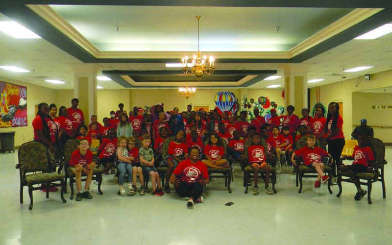 Astronaut in training Alyssa Carson and actor Eric Street pose with the students and staff of the Ville Platte Girls-Boys Place.