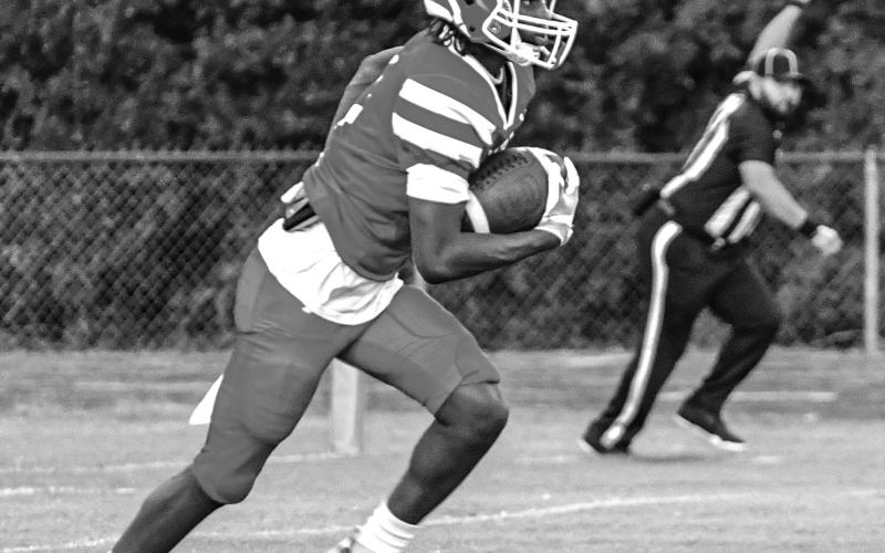 KICK-OFF RETURN - Marcus Evans takes the opening kickoff on his way to a 91-yard scoring gallop. (Photo by Tonya Ortego)