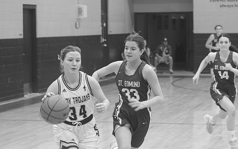 Taylor Darbonne (34) drives past a St. Edmund defender on her way to the goal in  Sacred Heart’s district clinching 30-23 win over the Lady Blue Jays on Tuesday night. (Gazette photo by Rhett Manuel)