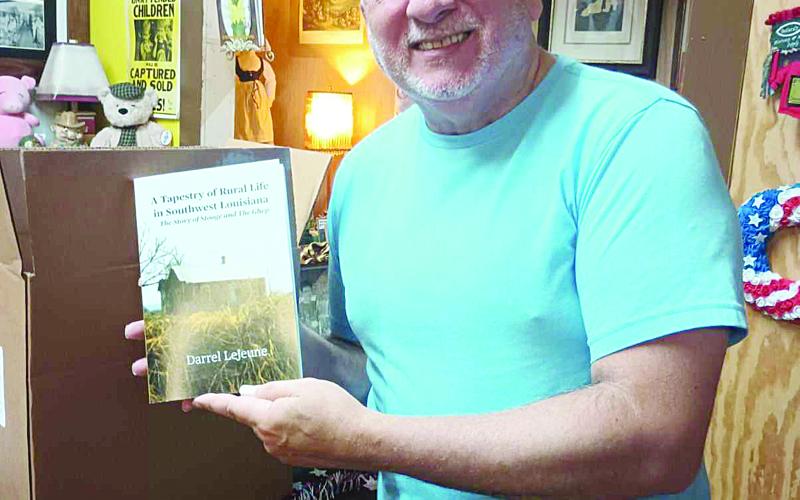 Darrel LeJeune shows off his newest book, a memoir about his late parents.