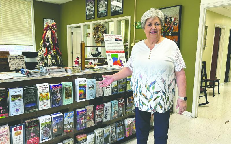 Debby Brunet, new executive director of Evangeline Parish Tourist Commission, shows off travel brochures and other items that are available inside the office, which is located on Main Street in Ville Platte. (Gazette photo by Heather Bogard)