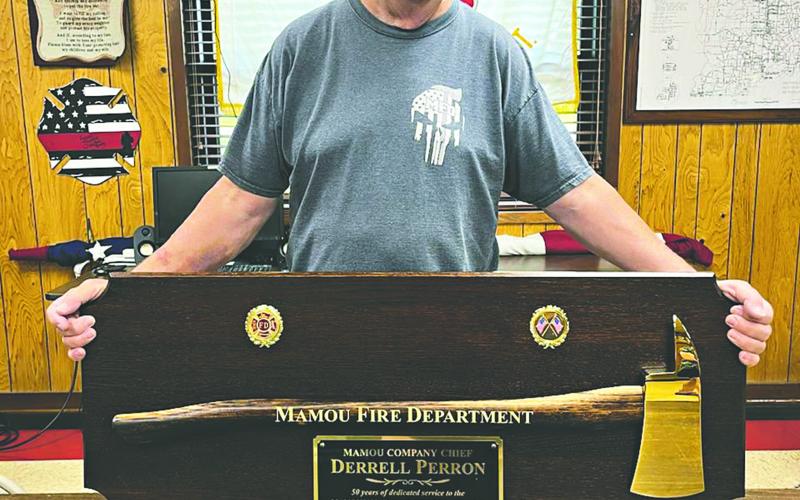 Derrell Perron is pictured with his award commemorating his 50 years of service to the Mamou Fire Department. (Photo courtesy of Mamou Fire Department)