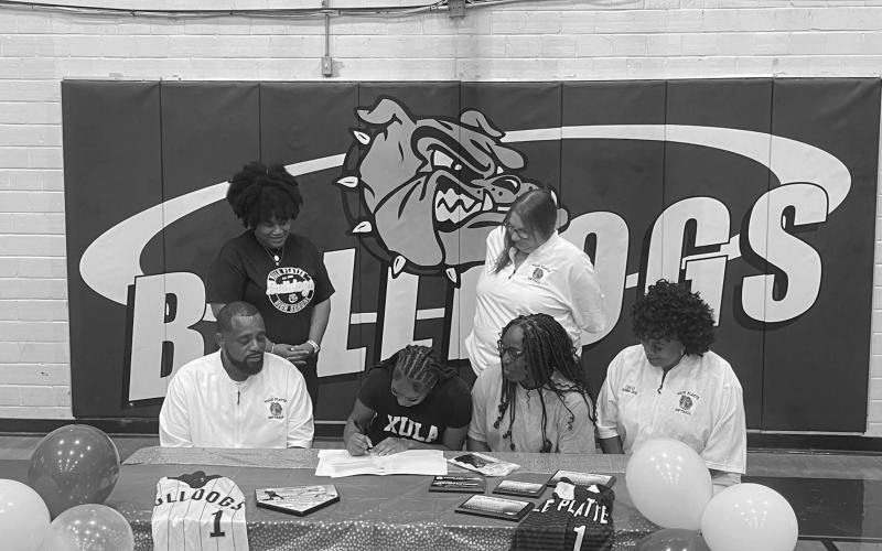 Destiny Lavigne (seated center left) is pictured as she signs to play college softball with Xavier University of Louisiana. Also pictured (from left) are standing Ville Platte High School Principal Shelsy Williams and former Ville Platte High School Assistant Principal Dawn Bellard; seated- Ville Platte High School Softball Coach Devinskie Arvie, Latoya Lavigne, and Ville Platte High School Assistant Coach Shonda Jack.