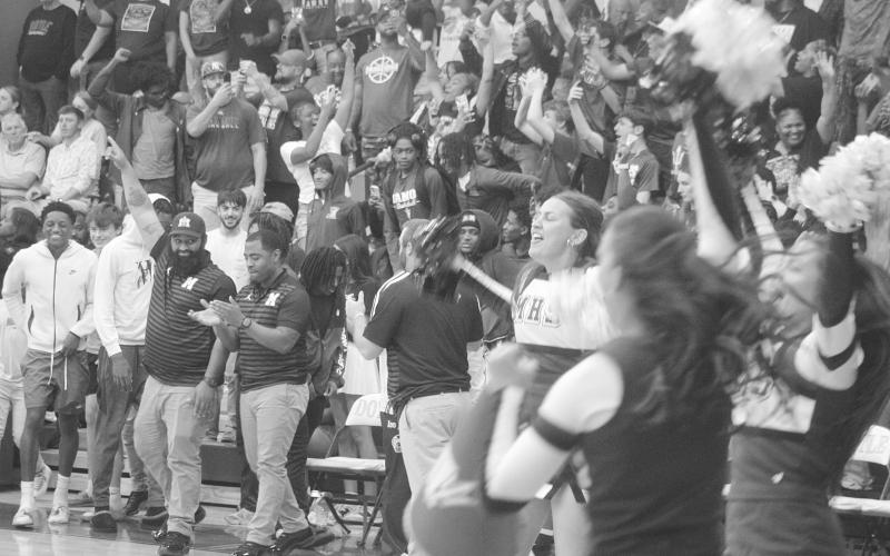 Members of the Mamou coaching staff and cheerleading squad, as well as other member of the Mamou community, celebrate after the Mamou Green Demons advanced to the state semifinals. With the win, the team moved on to play Marksville on Wednesday, March 11, at Burton Coliseum in Lake Charles. (Gazette photo by Tony Marks)