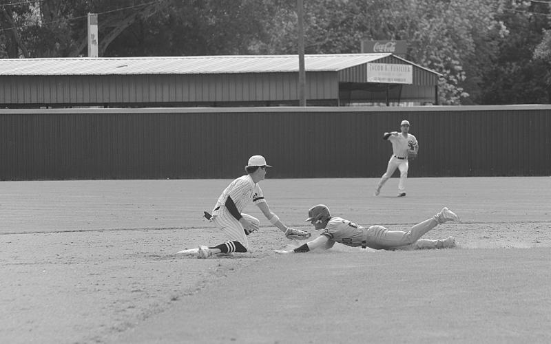 Rightfielder Wade Pitre (24) gives a celebratory fist bump as second baseman Hayden Droddy (9) retires a Catholic-Pointe Coupee runner on the base paths in Sacred Heart’s extra inning 4-2 loss on Monday, April 10. (Gazette photo by Rhett Manuel)
