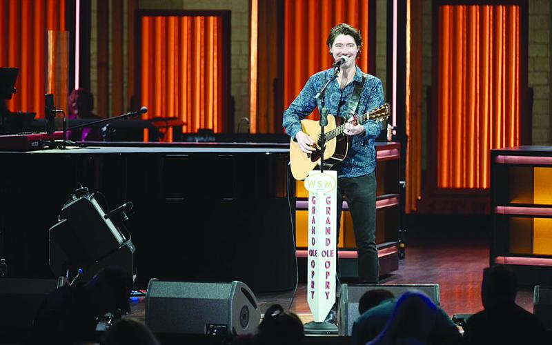 James Dupre is pictured as he makes his debut inside the “Sacred Circle” on stage of the Grand Ole Opry House. Dupre became the second native of Evangeline Parish to perform on the stage after Jimmy C. Newman. (Photo courtesy of Chris Hollo/ The Grand Ole Opry)