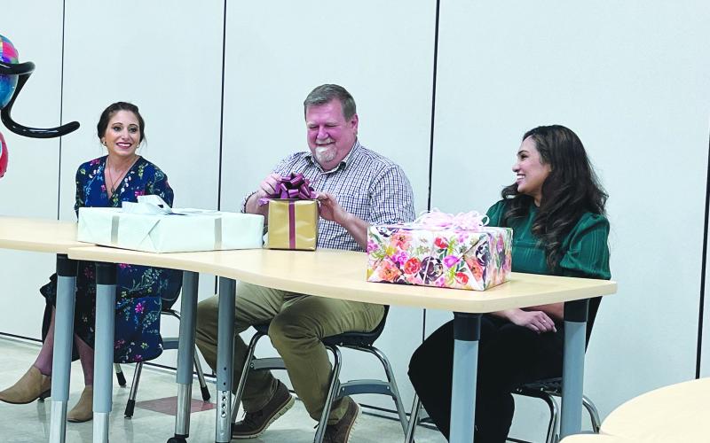 GIFTS PRESENTED - Jackie Prudhomme (left), elementary teacher at Chataignier Elementary and district winner; Chataignier Elementary junior high teacher and state semi-finalist Tim Comeaux (center); and Deepthi Nalli (right), Ville Platte High School teacher and district winner received gifts from the school board in recognition of their hard work during the contest. (Gazette photo by Heather Bogard)