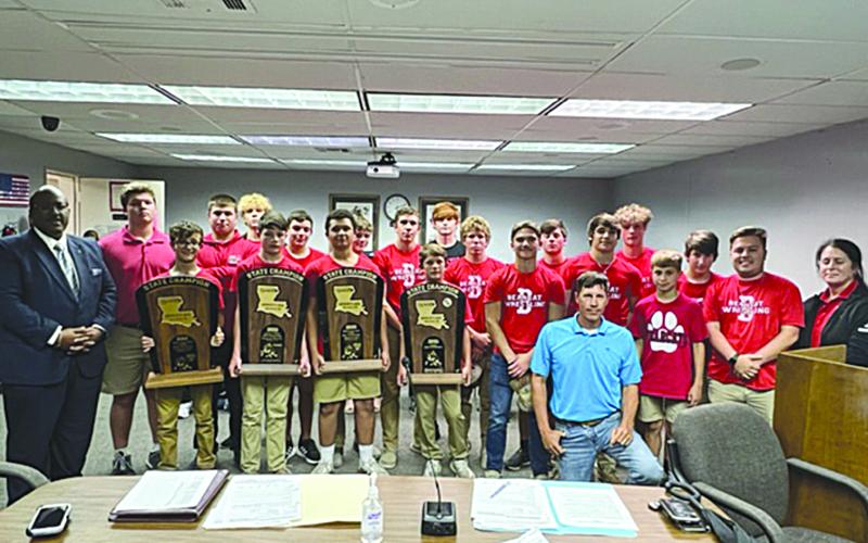 Members of the Basile wrestling team are pictured with Superintendent Darwan Lazard, Evangeline Parish School Board member Nick Chaumont, and Principal Helena Francois. From right are Coach Ben Bertrand, Parker Fontenot, John Wesley Sonnier, Luc Johnson, Pierson Comeaux, Brevan Fields, Tucker Leblanc, Cooper Berzas, Andre Johnson, Jayden Guillory, Jackson Courville, Drew Soileau, Cayden Luben, Austin Ashford, Logan Bergeron, William Ashford, Emery “Gumbo” Lejeune, Daniel Carter, and Scott Berzas.