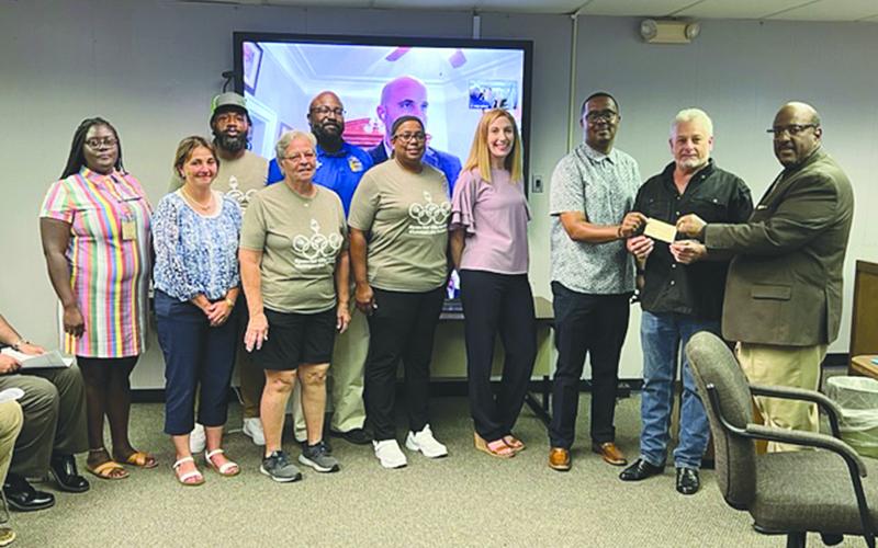 ROTARY OF VILLE PLATTE PRESENTS DONATION TO SPECIAL OLYMPICS - From left are: back row- Jorie Randle and Keith Scott; front row- Monette Doucet, Kelli LaFleur, Wanda Verrette, Dot Doulet, Nicole Johnson, Tommy Jones, Rotary Club of Ville Platte President-Elect Larry Lachney, and Superintendent of Schools Darwan Lazard. (Gazette photo by Tony Marks)