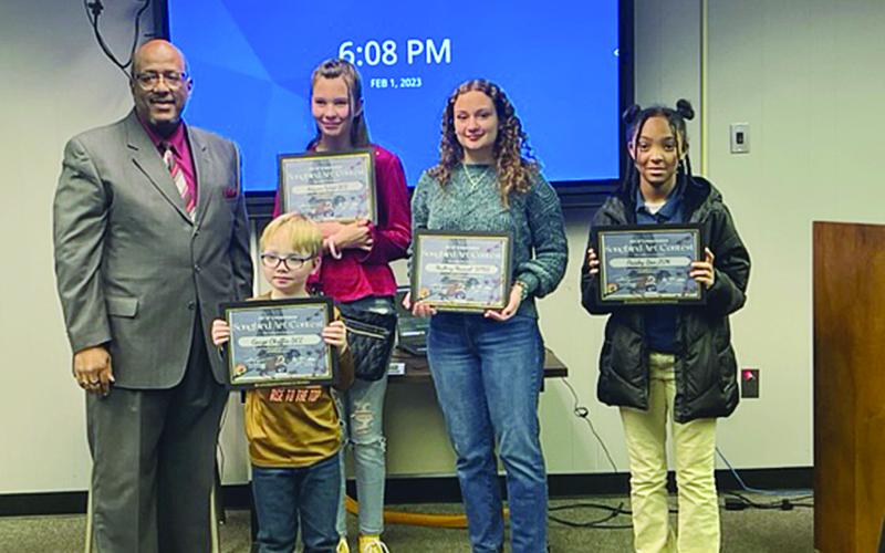 Evangeline Parish Superintendent Darwan Lazard (left) is pictured with talented art students. Pictured from left in the back are Adysen West, Mallory Manuel, and Paisely Ben. Pictured in the front is Gauge Chaffin. Not pictured are Macie Campbell, Trinity Williams, Pasey Sharp, and Madelyn Fontenot. (Gazette photo by Tony Marks)