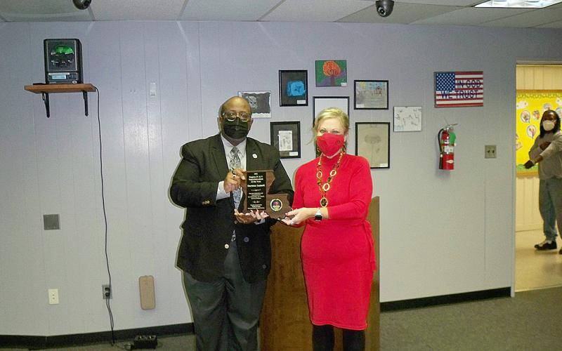Pictured is Superintendent Darwan Lazard (left) as he receives his superintendent of the year award from Dr. Gwile Freeman. (Gazette photo by Tony Marks)
