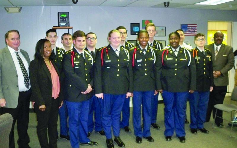 Pictured from left are (front row) Assistant Superintendent of Schools Michael Lombas, Ville Platte High Principal Chenile Tezeno, Riley Manuel, Tiffany Fontenot, Passion Lemelle, Carla Leday, Tyler Donaldson, and Superintendent of Schools Darwan Lazard; (back row) Jeremiah Manuel, Captain Jared Ski Doucet, Donald Keemun, Julian Salazar, Brennan Trosclair, and First Sergeant Jesse Fontenot. (Gazette photo by Tony Marks)