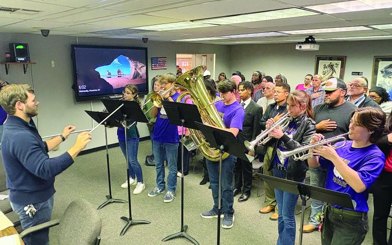 John Havard (left) conducts as members of the Pine Prairie High School Marching Band perform the National Anthem at the Evangeline Parish School Board meeting held Wednesday, November 20. From left are Kelly Monier, Camren Vidrine, Collin Vidrine, Adyson West, and Sarah Sullivan. (Gazette photo by Tony Marks)