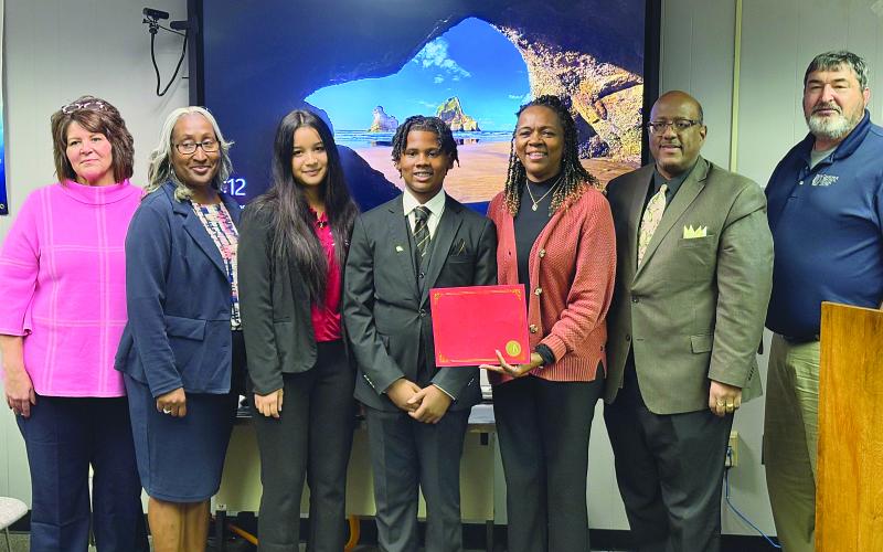 From left are Secondary School Supervisor Liz Chatelain, Mamou Junior High Principal Lisa Celestine, Mamou Junior High JAG students Brielle Woolman and Kendon Semien, Mamou Junior High JAG Specialist Carleen Ardoin, Superintendent Darwan Lazard, and School Board member Mike Fontenot. (Gazette photo by Tony Marks)