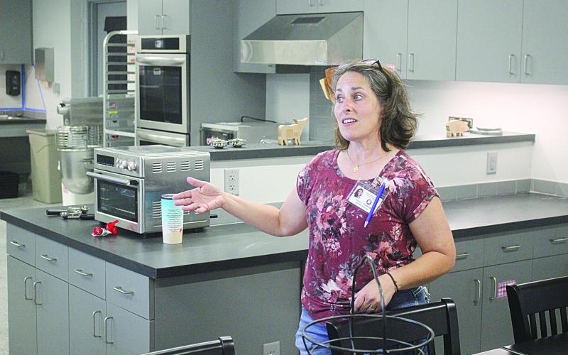 Erica L. Fontenot, assistant principal of Evangeline Reimagine Academy, shows off the school’s test kitchen and culinary area during an open house on Tuesday, August 10. (Gazette photo by Tony Marks)