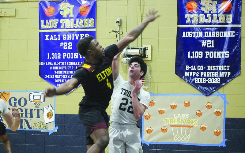 Nolan Johnson (22) manages to get off a shot from the court in Sacred Heart’s 44-36 win over Elton last Friday at home. (Gazette photo by Tony Marks)