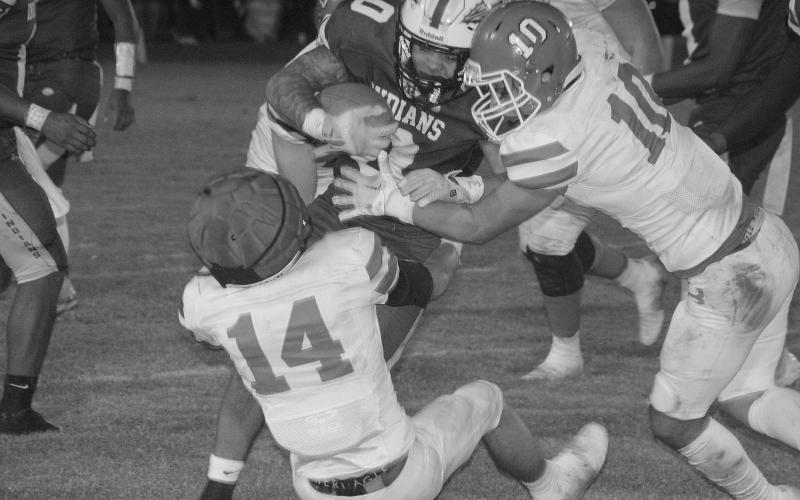 Pierson Comeaux (14) and Carter Darbonne (10) look to make a tackle against an Elton runner in Basile’s playoff loss last Friday. (LSN photo by Rhett Manuel)