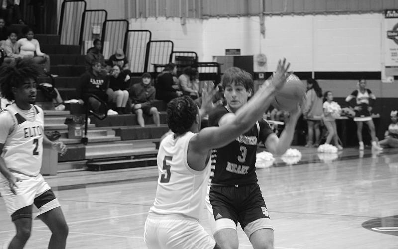 Gabe Fontenot (3) tries to pass the basketball to a Trojan teammate. (Gazette photo by Tony Marks)
