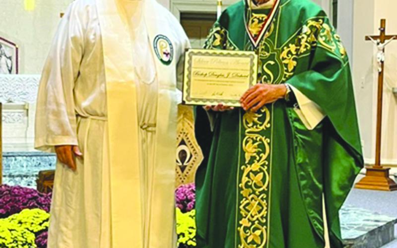 Bishop Douglas Deshotel, a Basile native, (at right) receives the Silver Pelican award from Father Ken Domingue, scout chaplain and former pastor at Basile’s St. Augustine Catholic Church and former associate pastor of Sacred Heart of Jesus Catholic Church in Ville Platte.