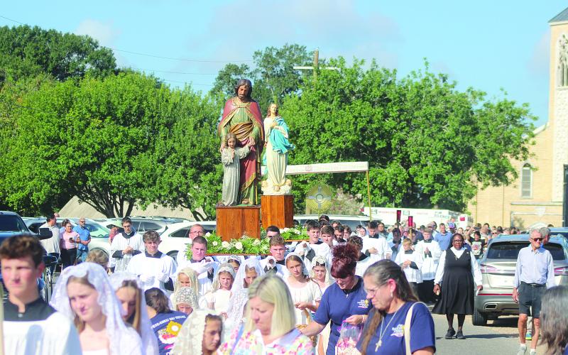 Statues of St. Joseph and the Blessed Virgin Mary proceed ahead of Jesus in the Blessed Sacrament as a foot procession is held from St. Leo the Great Catholic Church to the boat landing on the Bayou Teche in Leonville as part of the Fête-Dieu du Teche Eucharistic Boat Procession on Saturday, August 15. (Gazette photo by Tony Marks)