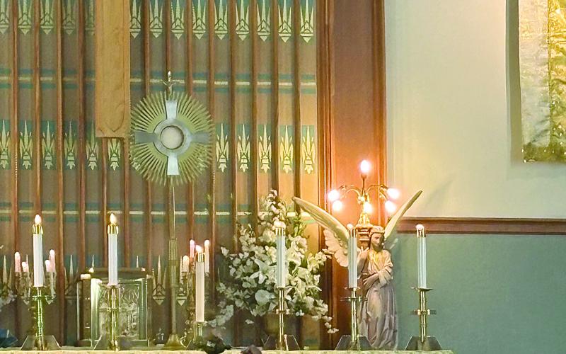 Fr. Michael Champagne, of the Community of Jesus Crucified, incenses Jesus in the Blessed Sacrament during Mass held in St. Leo the Great Catholic Church. (Gazette photo by Tony Marks)