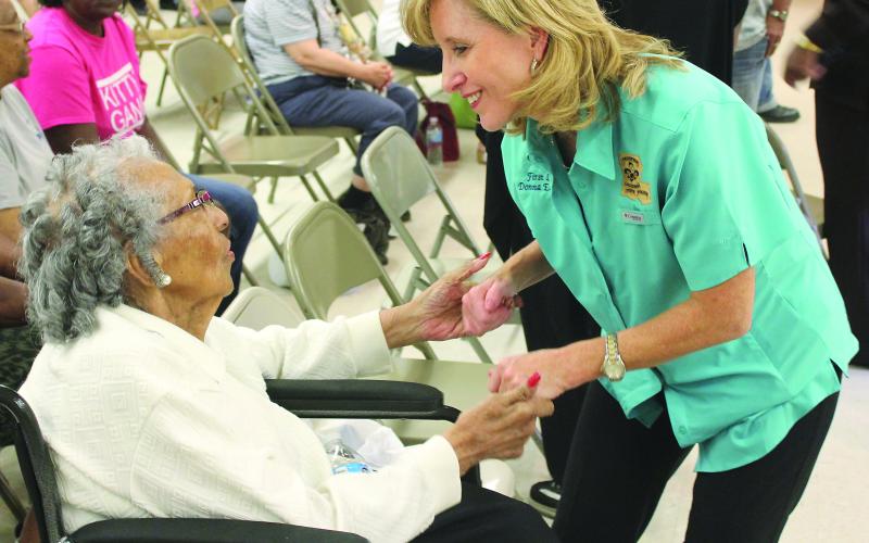 AUGUST 21, 2016 - First Lady of Louisiana Donna Edwards talks to 85-year-old Pearl Godfrey, of Ville Platte, at the Ville Platte Civic Center on Friday. Edwards stopped by Ville Platte to talk to residents affected by the historic flooding. (Gazette photo by Raymond Partsch III)