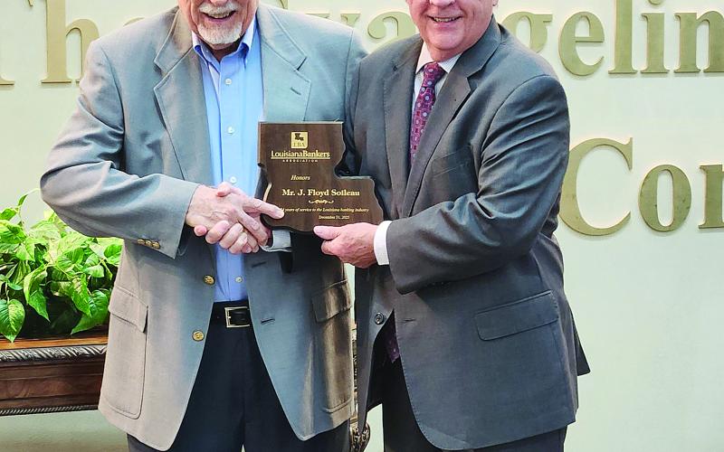 Floyd Soileau (left) is pictured as he receives a commemorative plaque for 54 years of service on The Evangeline Bank and Trust Company’s Board of Directors. He was presented the plaque by the bank’s President, Chief Executive Officer, and Chairman of the Board Randel Chapman during a ceremony held Friday, January 9. (Photo courtesy of The Evangeline Bank and Trust Company)