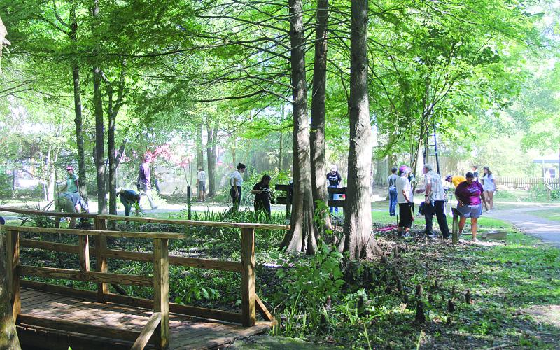 Several volunteers are pictured as they help clean up the Ville Platte Native Plant Heritage Garden on Saturday, August 5. (Gazette photos by Tony Marks)