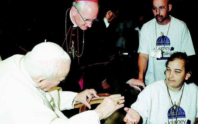MEETING THE POPE - Nicole Lynn Soileau, the daughter of Harold Soileau and Fannie Soileau, both of Ville Platte, recently took part in a pilgrimage where she got the chance to meet Pope John Paul II in Rome. Nicole is shown here with the Pope. Also shown is her assistant, Keith Delano of Abbeville, back right.