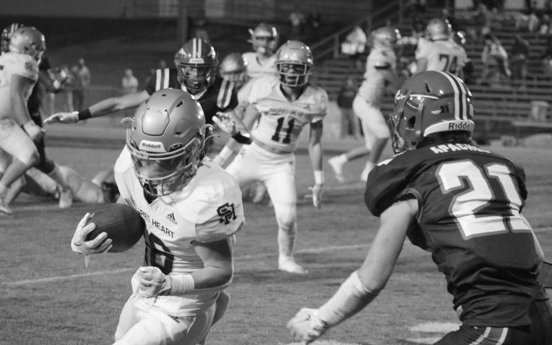 Boyce Schexnider (16) looks for yards after the catch in Sacred Heart’s playoff loss to Glenbrook School last Friday night. (Gazette photo by Tony Marks)
