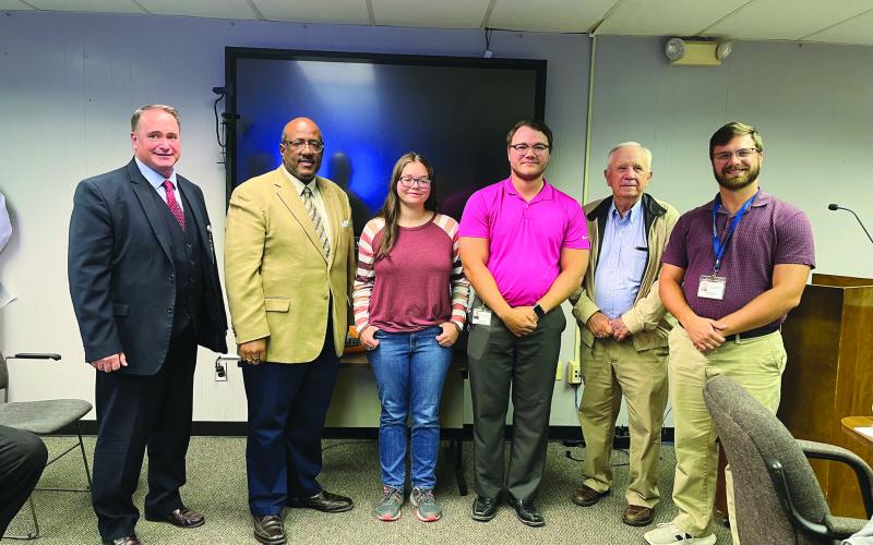 PINE PRAIRIE STUDENT RECOGNIZED - Grace Bordelon, a senior at Pine Prairie High School, was recognized for being the only student to make the top state symphonic honor band. She is shown with, from left, Assistant Superintendent Mike Lombas, Superintendent Darwan Lazard, Pine Prairie Band Director John Havard, School Board President Wayne Dardeau and Pine Prairie Talented Music/Percussion Director Taylor Naquin. (Gazette photo by Heather Bogard)