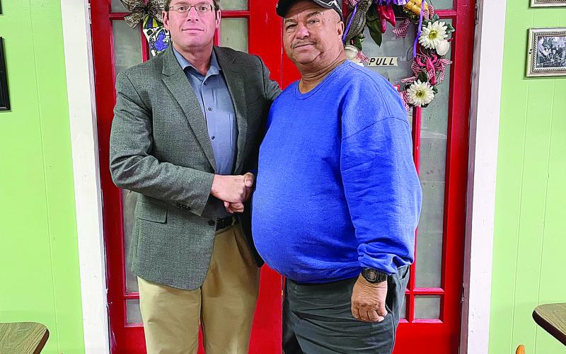 Pictured is Bradley McDonald of Acadiana Waste Services, LLC, (left) as he congratulates Hampton Frank (right) on his recent retirement. (Photo courtesy of Bradley McDonald)