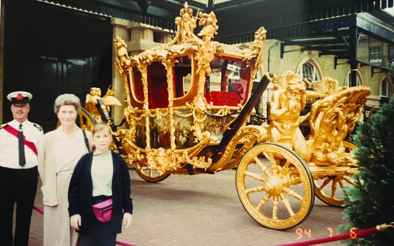 POSING WITH HISTORY - Iris LaTour and granddaughter Heather LaTour (Bogard) pose in front of the royal Gold State Coach, which has carried many royals to special events, including Queen Elizabeth II to her coronation on June 2, 1953. The coach was commissioned by King George III in 1760 and completed in 1762. (Gazette photo courtesy Heather Bogard)