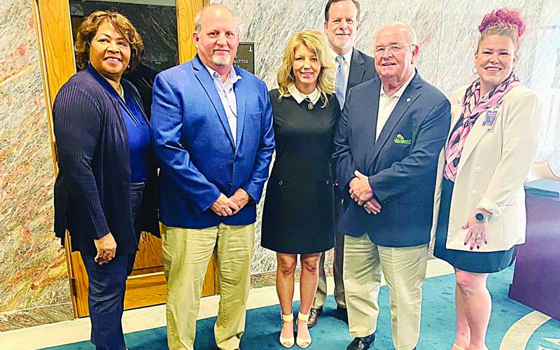 Among those pictured with State Senator Heather Cloud (center) are Woodworth mayor David Butler (left of center) and Addis mayor David Toups (right of center). (Photo courtesy of Senator Heather Cloud)